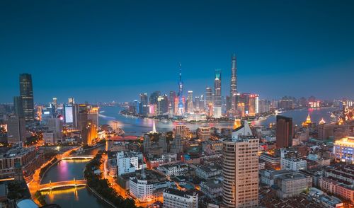 Aerial view of city lit up at night