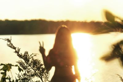Silhouette of woman in sunlight at sunset
