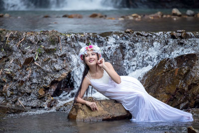 Portrait of a smiling young woman in water