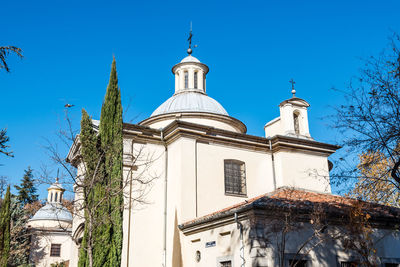 Low angle view of bell tower against blue sky