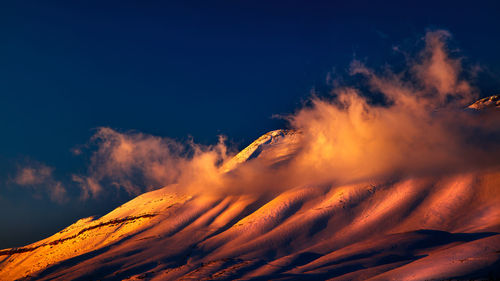 Scenic view of desert against sky at night