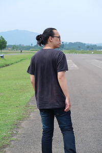 Full length of young man standing on road