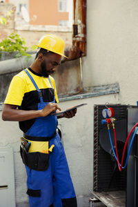 Rear view of man working in factory