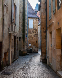 Narrow street amidst buildings in city