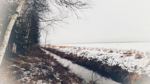 Scenic view of landscape against sky during winter