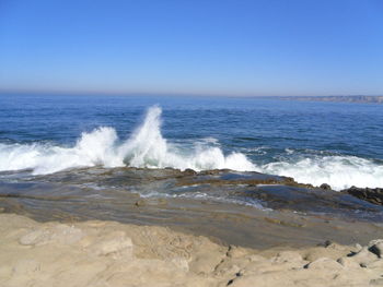 Scenic view of sea against clear blue sky