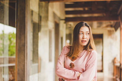 Beautiful mid adult woman standing in corridor