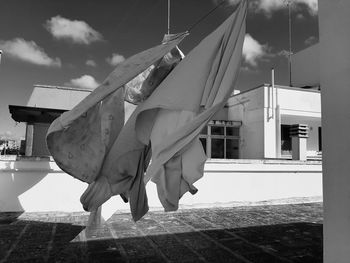 Low angle view of clothes drying against buildings