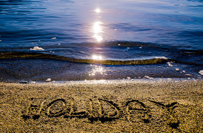 Close-up of text on beach