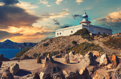 Panoramic view of sea and buildings against sky during sunset