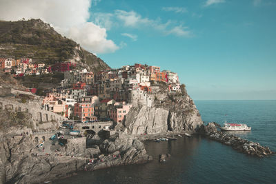 Panoramic view of buildings by sea against sky