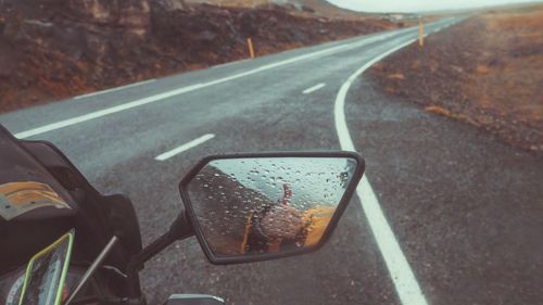 Wet road seen through car windshield