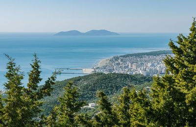 High angle view of sea and trees against sky