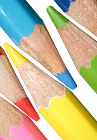 Close-up of multi colored pencils on wooden table