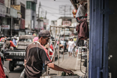 Man working on street in city