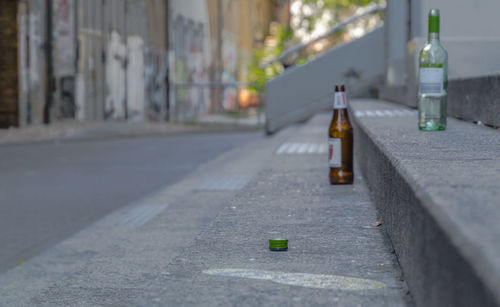 Close-up of bottles on street