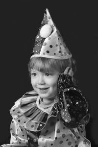 Portrait of a smiling girl over black background