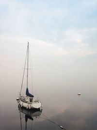 Sailboat sailing on sea against sky