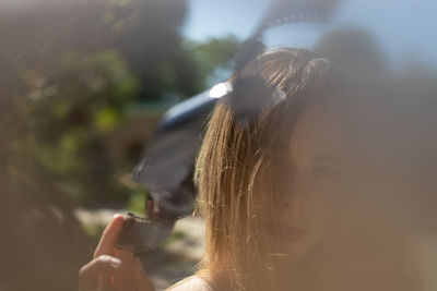 Portrait of woman holding cigarette