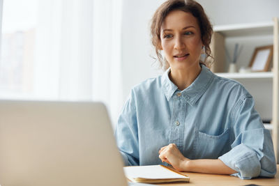 Businesswoman using laptop at office