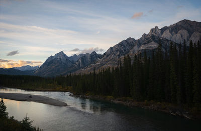 Scenic view of river amidst mountains against sky