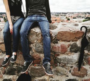Low section of men sitting outdoors