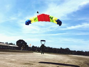Full length of man paragliding against sky