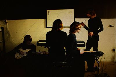 Full length of woman sitting on bench
