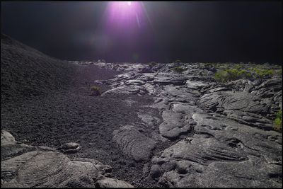 Aerial view of rocks on land against sky at night