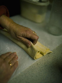 Close-up of cropped woman preparing food at home