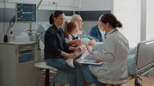 Female doctor examining patient in clinic