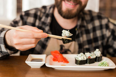 Midsection of man holding cake