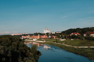 River amidst buildings against sky