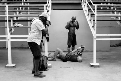 Full length of shirtless man sitting on floor