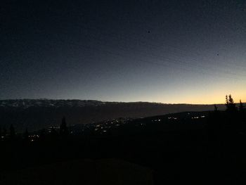 Scenic view of silhouette illuminated against sky at night