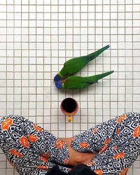 Directly above shot of person hand holding coffee cup on floor