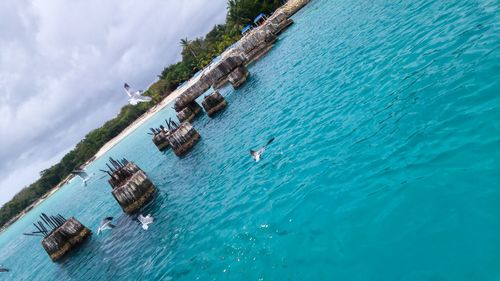 Low angle view of swimming pool in sea against sky