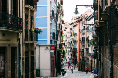 Street amidst buildings in city against sky