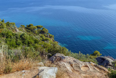 High angle view of rocks by sea against sky