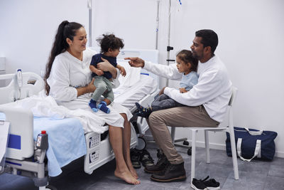 Parents with children in hospital room