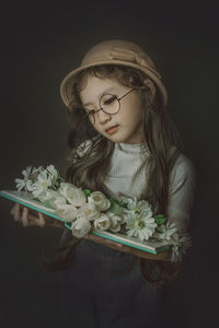 Close-up of young woman holding flower