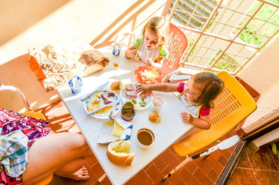 High angle view of woman sitting on table