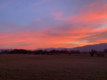 Scenic view of field against sky during sunset