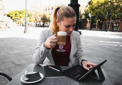 Blonde girl working in the coffee shop 