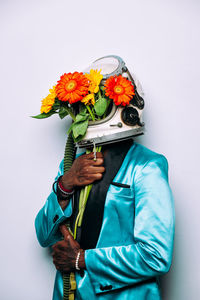 Low angle view of person holding umbrella against white background