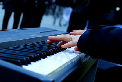 Close-up of hands playing piano