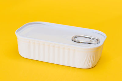 Close-up of usb stick against yellow background