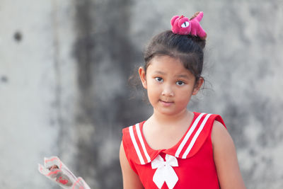 Portrait of cute girl against blurred background