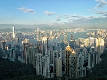 Aerial view of city against cloudy sky