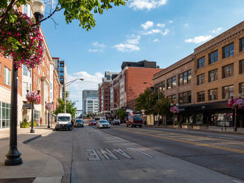 City street by buildings against sky